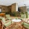 Spacious and well lit game room with billiard tables and plenty of seating.