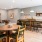 Spacious community kitchen with long table and all appliances. 