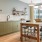 Spacious community kitchen with long table and all appliances. 