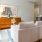 Spacious and well lit living room with wood floors and an open floor plan with access to the kitchen.