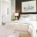 Spacious and well lit bedroom with wood floors and a large window