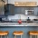 Spacious and well lit kitchen with wood floors and stainless steel appliances. 