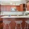 Spacious and well lit kitchen with wood floors and stainless steel appliances. 